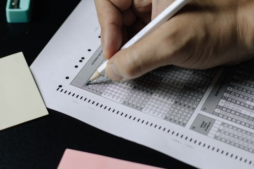 A sales person scoring the lead of a sales prospect on a piece of paper