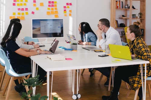 A presentation in a meeting room discussing digital agency software options