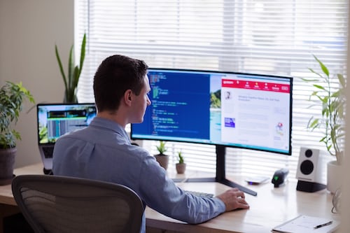 A salesperson at his desk researching digital agency software solutions